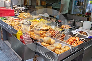 A street food stall in Hong Kong selling different types of deep fries and barbecued food. Demonstrating Asian street food culture