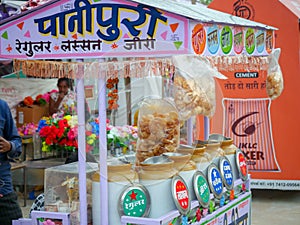 Street food vendor selling Water balls also known as pani puri in india on stall.