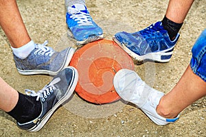 Street football. Boys feet with the ball in the sand