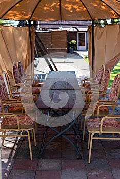 Street gazebo with tables and chairs in the middle outside