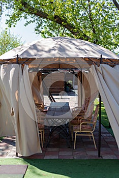 Street gazebo with tables and chairs in the middle outside