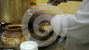 A street hawker garnishing freshly made Chole with sliced Dhania and Adrak - Street food, India