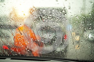 Street in the heavy rain. Water drops or rain in front of mirror of car on road or street