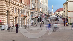 Street with historic buildings in citycentre and Holy Mary monument in front of the Cathedral timelapse in Zagreb