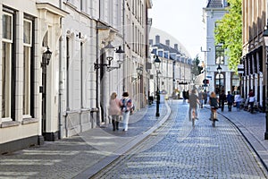 Street with historical buildings and motion blur pedestrians