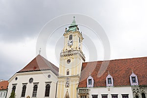 Street with houses and church in Slovakia, rainy weather