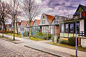 A street with houses in the old town in WarnemÃ¼nde at the old harbor. Rostock, Germany