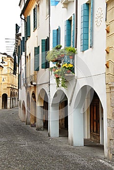 Street in Italy, terrace with flowerpots