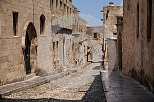 Street of knights in Rhodes city. Ruins of the castle and city walls of Rhodes. Narrow streets of the old town.