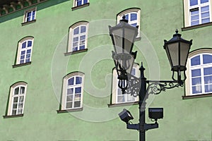 Street lamp in front of green-wall windows photo