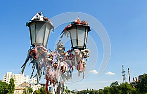 Street lamp with colored ribbons and locks