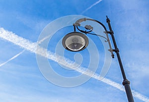 Street lamp and contrails