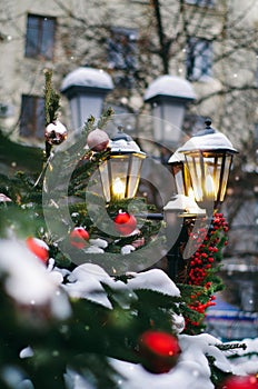 Street lamp decorated with christmas staff pine cones, red berries, fir bunch