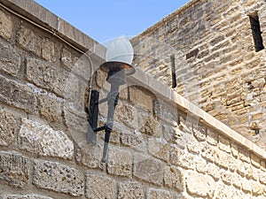 Street lamp in the form of a torch on the fortress wall