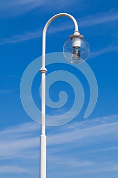 Street lamp in front of blue sky