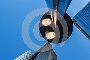 Street lamp at front of windows of corporate business office buildings