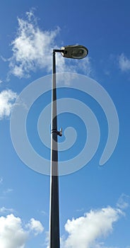 Street lamp with head under clouds