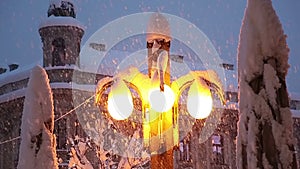 Street lamp while heavy snowing