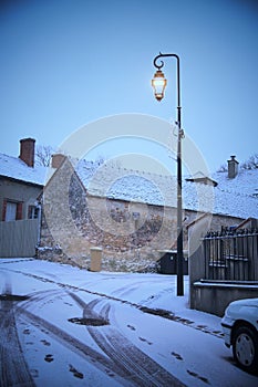 Street lamp next to an antique building in Saint-Loup-de-Naud