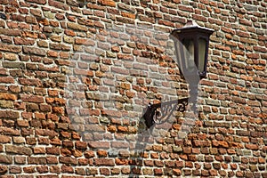 Street lamp on the old brick wall
