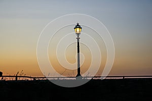 Street lamp over sunset