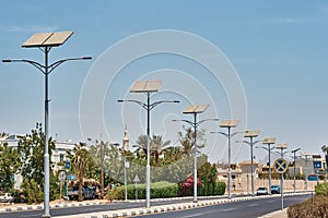 Street lamp powered with a solar panel battery against blue sky.  Alternative energy and save ecology concept