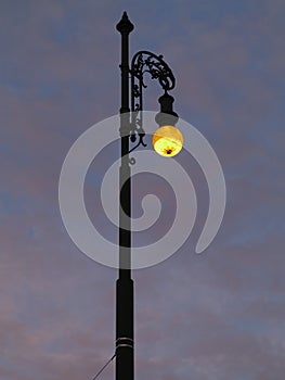 Street lamp shining at dusk