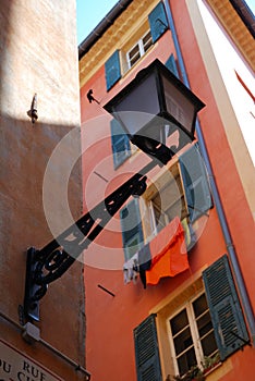 Street lamp and wall with open shutters, Nice