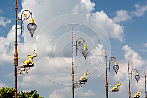 street lamps with elephant sculpture against bluet sky