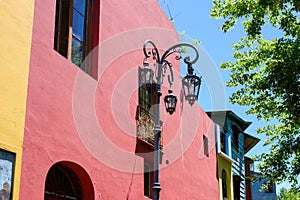 Street lamps in front of colorful buildings of La Boca, nightlife district, Buenos Aires, Argentina.