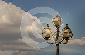 Street lamps on Metal pole against the background of cloudy blue sky by Afternoon sun