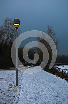 Street lamps  on a road with snow