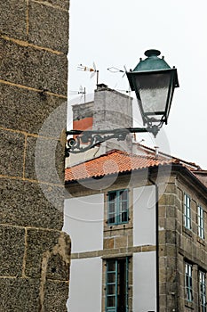 Street lantern on a stone wall in the medieval street, Santiago de Compostela, Galicia, Spain