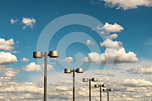 Street lanterns of steel color against the blue sky and beautiful clouds, Dnipro city, Ukraine