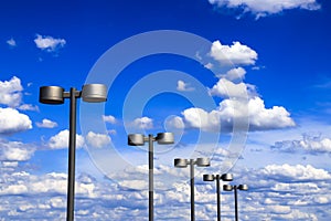 Street lanterns of steel color against the blue sky and beautiful clouds, Dnipro city, Ukraine