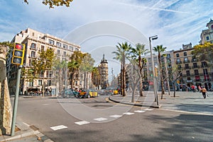 Street level view of pleasant day in Barcelona sunny afternoon, people at cafes, walking or relaxing in a park.