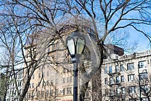 Street Light at Central Park with Residential Buildings in Harlem of New York City in the Background