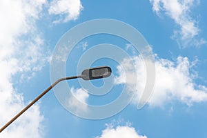 Street light with halogen lamp against blue sky