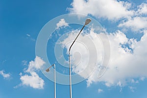 Street light with halogen lamp against blue sky