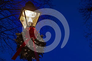 Street light pole adorn with a Christmas wreath.