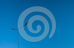 The street light pole with a blue sky background - Automatic street twin lamp against the blue sky with copy space