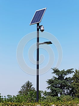Street lighting pole with photovoltaic panel and surveillance camera