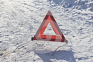 Street lighting. white snow. street lighting. white snow. There`s a pack sign on it. Warns of a car breakdown or danger. It is