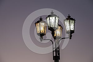 Street lights are located on the streets of the city and illuminate everything around the black night