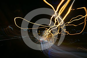 Street lights in speeding car in night time, light motion with slow speed shutter view from inside front of car.