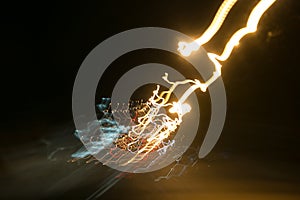 Street lights in speeding car in night time, light motion with slow speed shutter view from inside front of car.