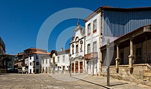 Street in Mirandela with residential houses and Church of Mercy, Portugal