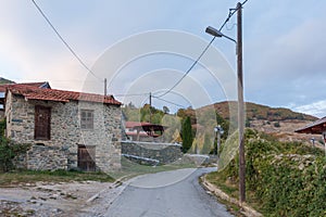 Street in the mountainous Kratero village in Florina, Greece, with old stone houses and Autumn colours