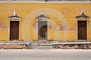 Street in Muna, Yucatan, Mexico with yellow wall and doors