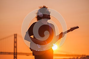 Street musician playing electric guitar in the street